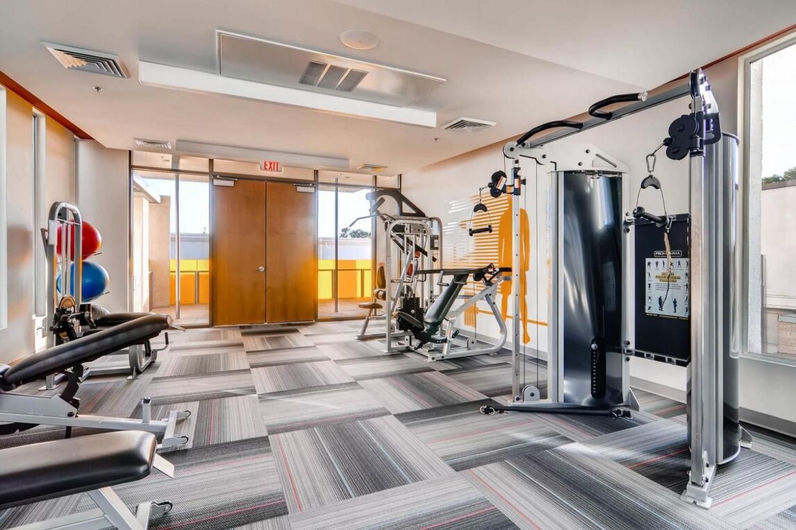 fitness center with cardio machines and free weights