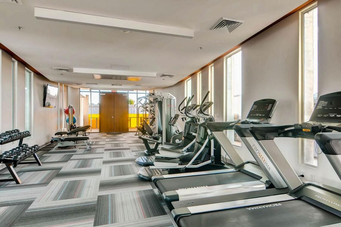 fitness center with cardio machines and free weights