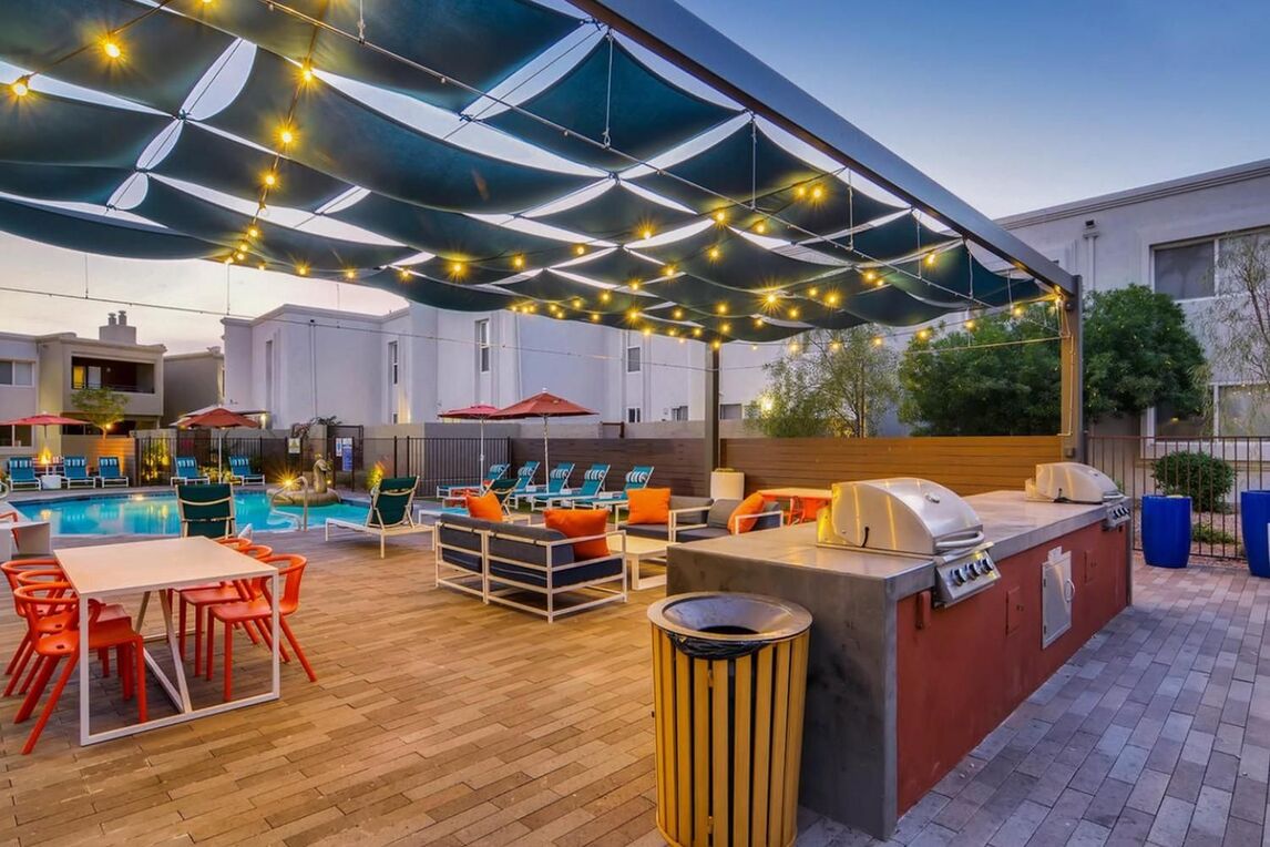 Swimming pool and view of deck and colorful chairs